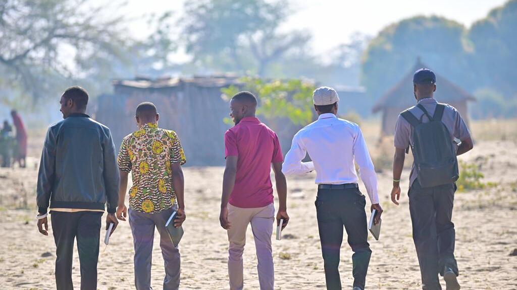A group of young men walking with the bible to go spread the gospel