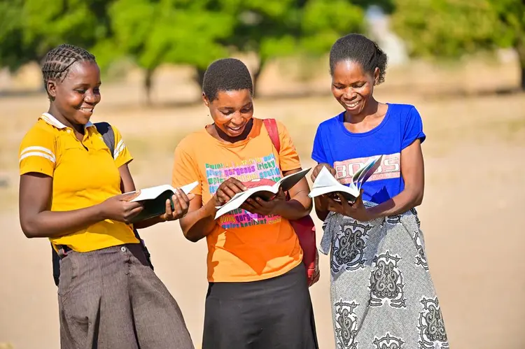 Ladies exictedly reading the bible in Kwamashi language for the first time 