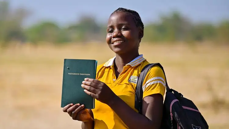 Young girl holding the kwamashi bible