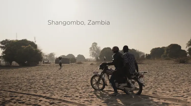 2men riding a motorbike in shangombo sch ground